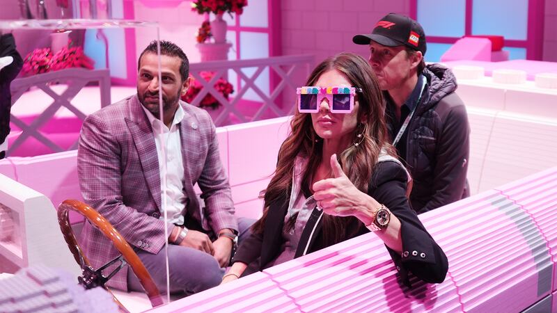 FBI director Kash Patel and Secretary of Homeland Security Kristi Noem sit in a pink Cadillac made of LEGO blocks before the Formula One Las Vegas Grand Prix auto race, on Nov. 22, 2025 in Las Vegas.