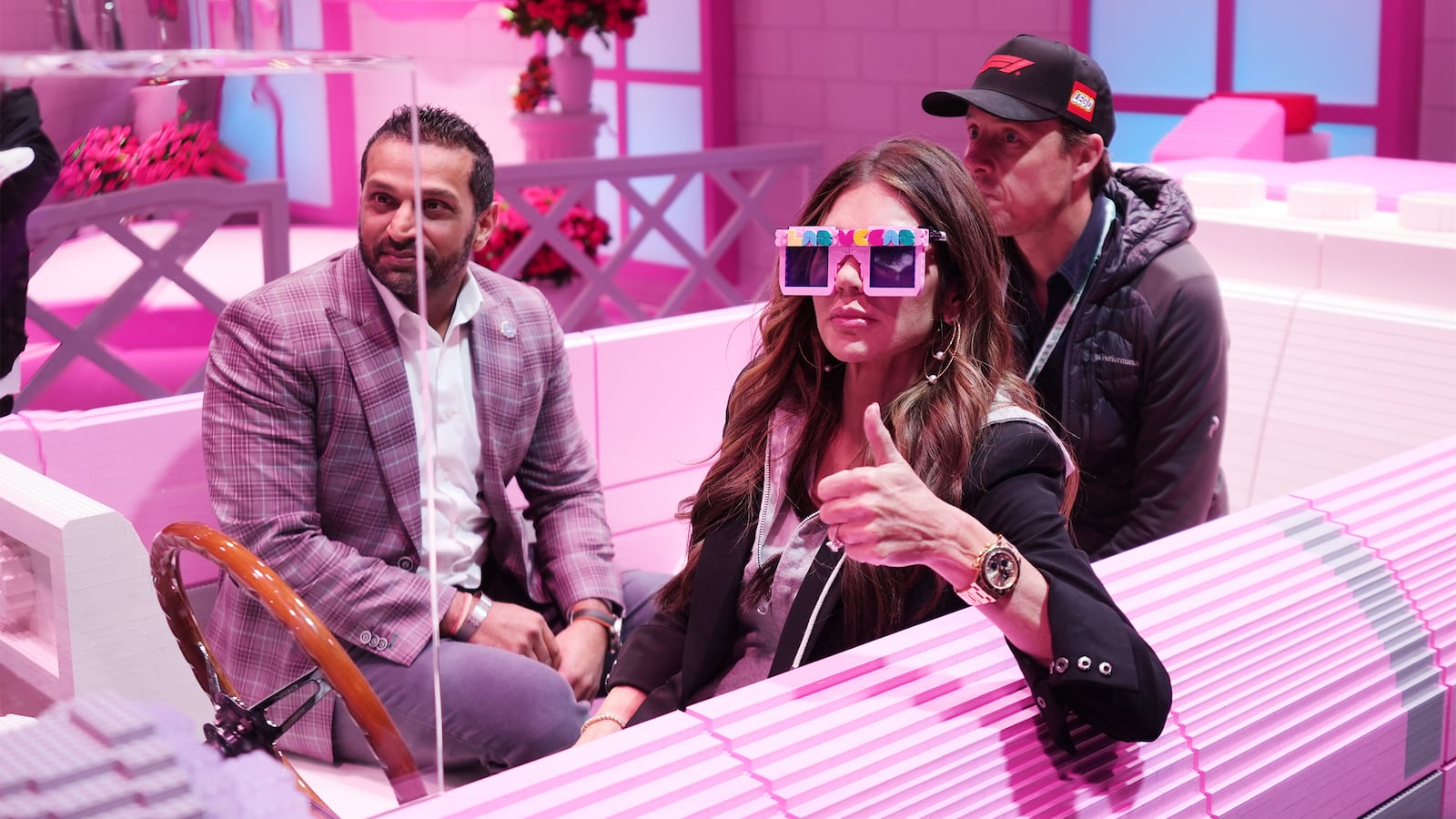 FBI director Kash Patel and Secretary of Homeland Security Kristi Noem sit in a pink Cadillac made of LEGO blocks before the Formula One Las Vegas Grand Prix auto race, on Nov. 22, 2025 in Las Vegas.