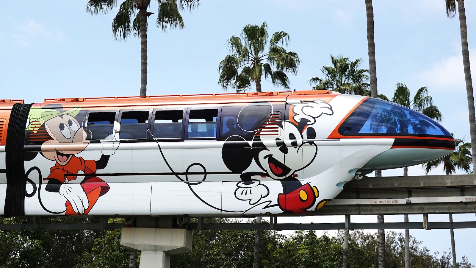 ANAHEIM, CALIFORNIA - APRIL 24: The Disneyland monorail passes near palm trees on April 24, 2023 in Anaheim, California. Disney will lay off several thousand workers this week amid an overall push by the media giant to cut 7,000 total jobs in an effort to save $5.5 billion in costs. (Photo by Mario Tama/Getty Images)