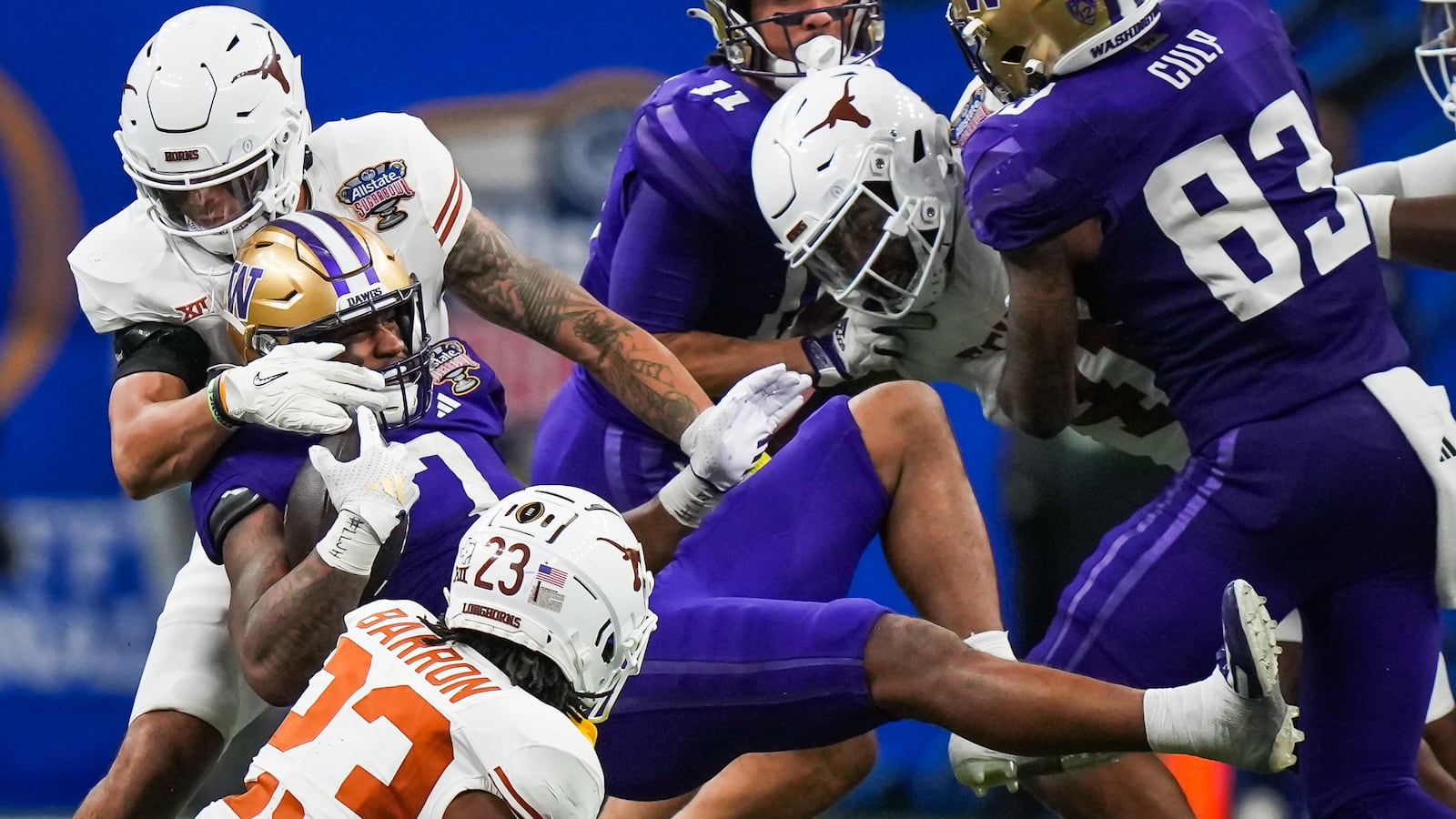 Texas defense tackle Washington Huskies running back Dillon Johnson (7) in the fourth quarter in the 2024 Sugar Bowl college football playoff semifinal game at Caesars Superdome.