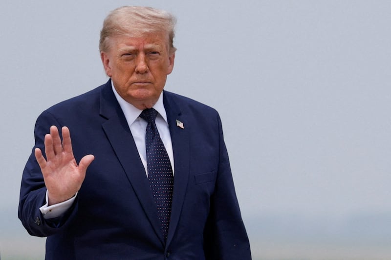 President Donald Trump gestures on the tarmac, as he heads to board the new Qatari-gifted Air Force One en route to New York City, at Joint Base Andrews, Maryland on July 17, 2026.