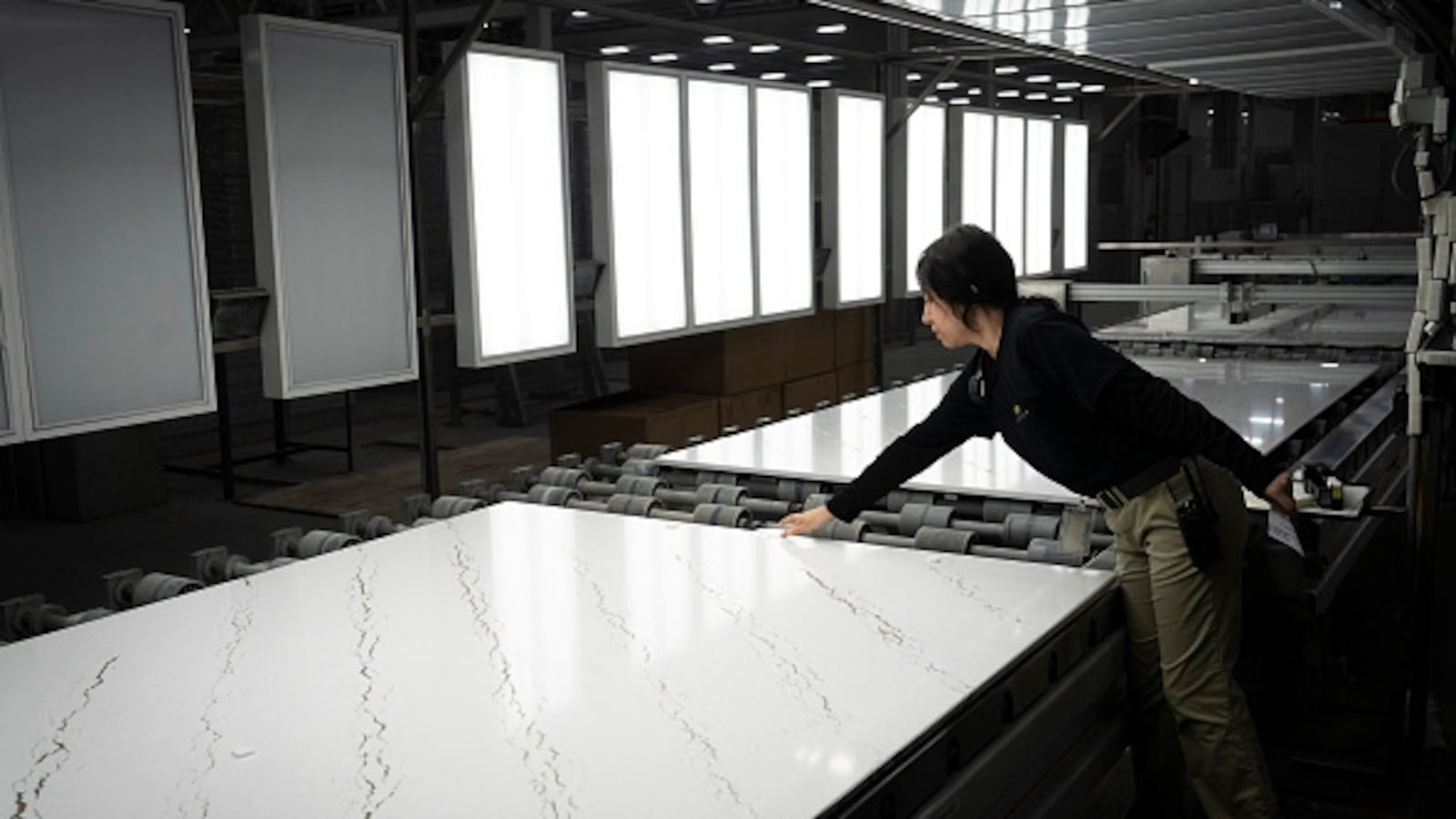 LESAEUR, MN. - NOVEMBER 2022: Alicia Rodriguez, a one-year employee in quality control, makes sure each slab is level at Cambria on Monday, Nov. 7, 2022, in Le Sueur, Minn. (Photo by Renee Jones Schneider/The Minnesota Star Tribune via Getty Images)