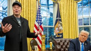 Elon Musk speaks as US President Donald Trump looks on in the Oval Office of the White House in Washington, DC, on February 11, 2025. Tech billionaire Elon Musk, who has been tapped by President Donald Trump to lead federal cost-cutting efforts, said the United States would go "bankrupt" without budget cuts. Musk leads the efforts under the newly created Department of Government Efficiency (DOGE), and was speaking at the White House with Trump, who has in recent weeks unleashed a flurry of orders aimed at slashing federal spending. (Photo by Jim WATSON / AFP) (Photo by JIM WATSON/AFP via Getty Images)