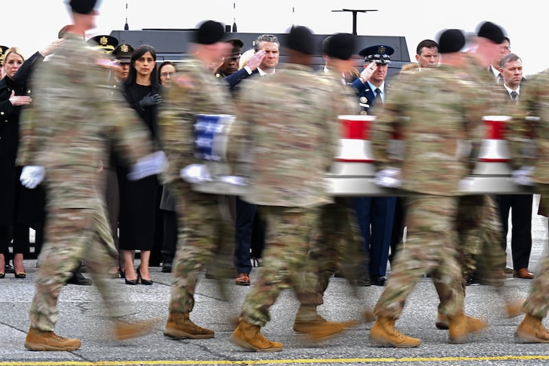 (L-R) Second lady Usha Vance and U.S. Secretary of War Pete Hegseth salute as a U.S. Army carry team moves a flag-draped transfer case containing the remains of Sgt. 1st Class Noah L. Tietjens at Dover Air Force Base March 07, 2026 in Dover, Delaware.
