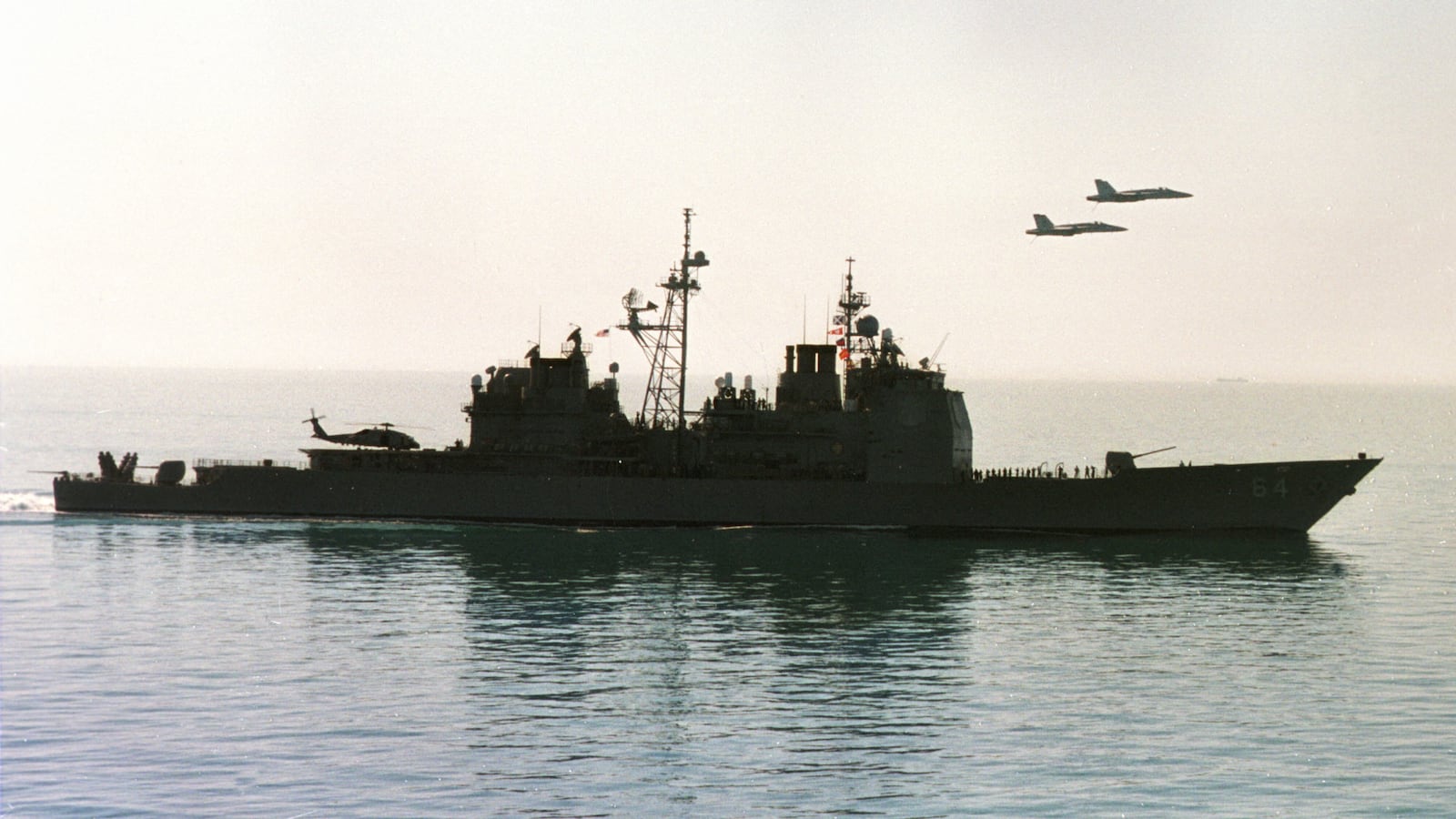 Two F/A-18 jet fighters from the USS Enterprise pass over the US Navy cruiser USS Gettysburg 21 December during a ceremony honoring the "Raging Bulls" squadron that participated in Operation Desert Fox.
