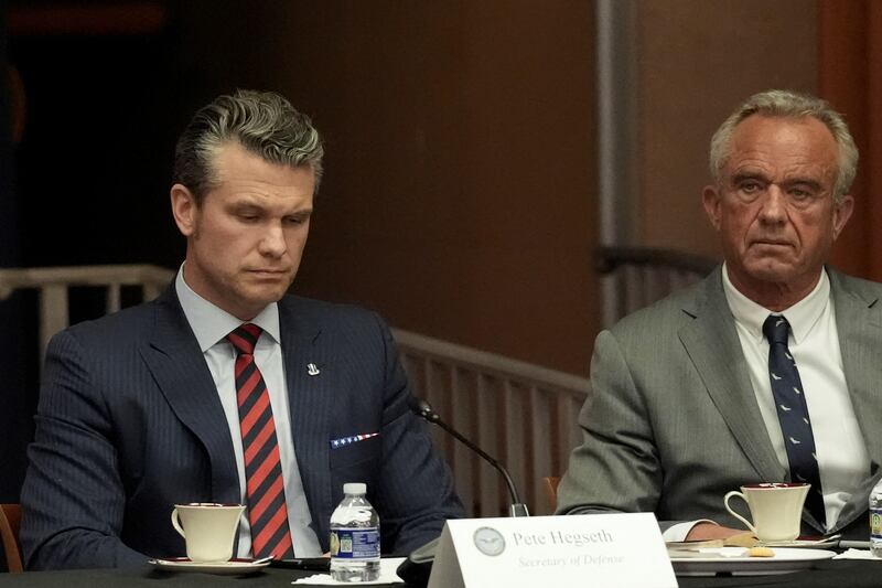 U.S. Secretary of Defense Pete Hegseth and U.S. Health and Human Services Secretary Robert F. Kennedy, Jr. attend a meeting of the Eradicating Anti-Christian Bias Task Force, at the Justice Department in Washington, D.C., U.S., April 22, 2025. REUTERS/Ken Cedeno