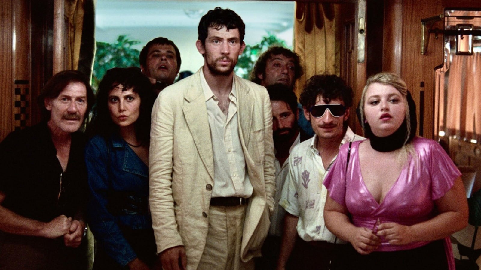 Josh O’Connor and the cast of ‘La Chimera’ stand together in a still from the movie.