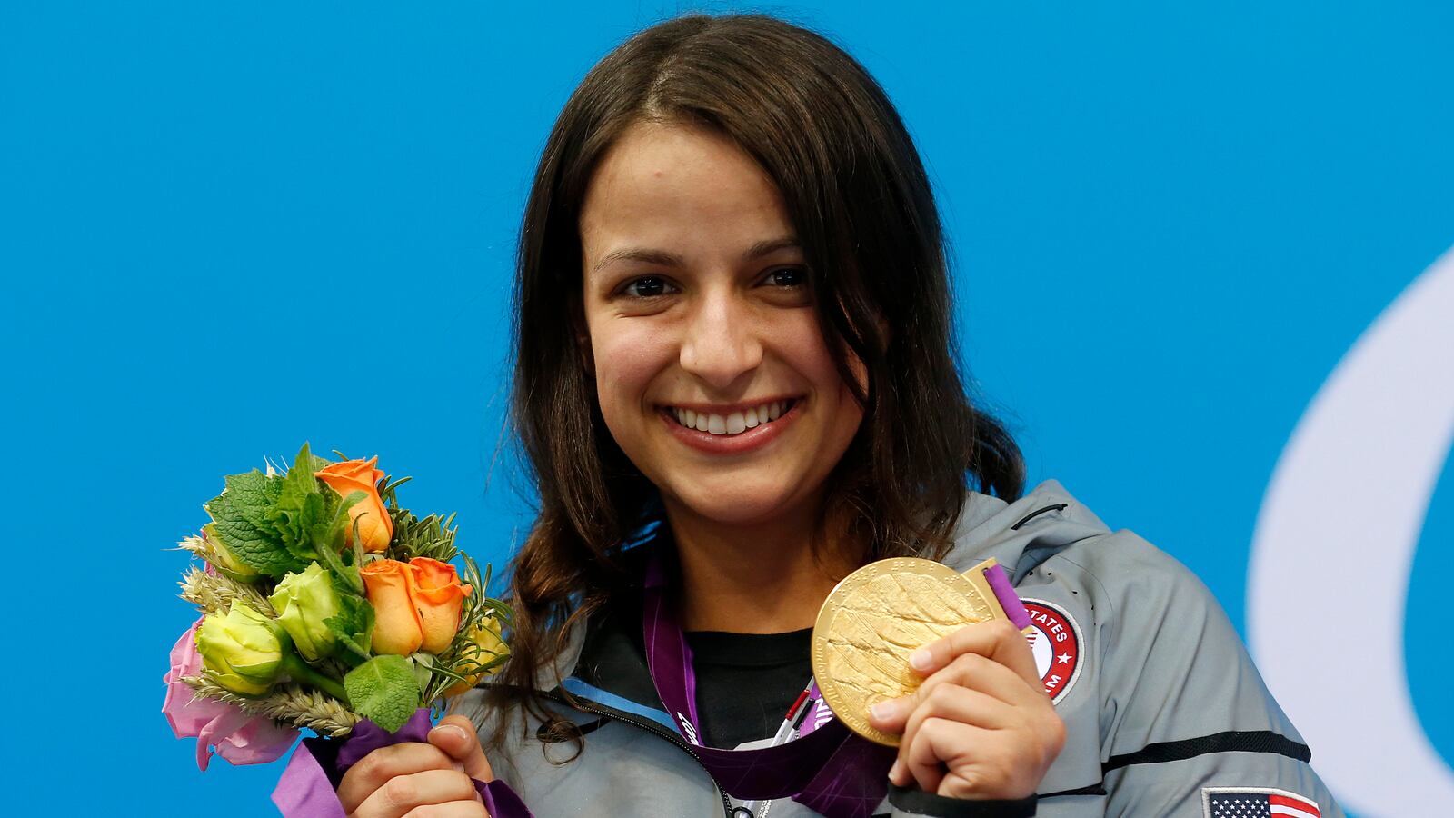Victoria Arlen of the U.S. holds the gold medal she received for the women's 100m freestyle.