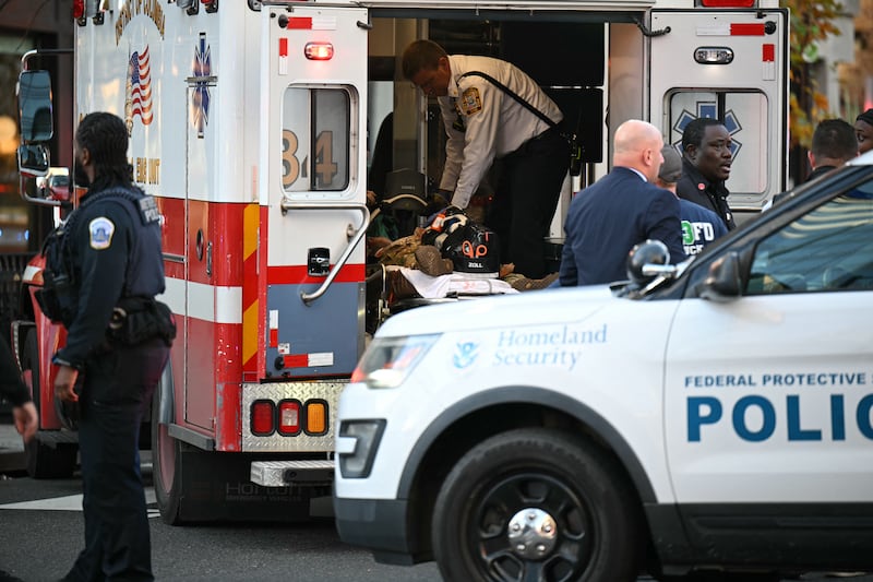 An unidentified man in military fatigues lies on a stretcher inside an ambulance.
