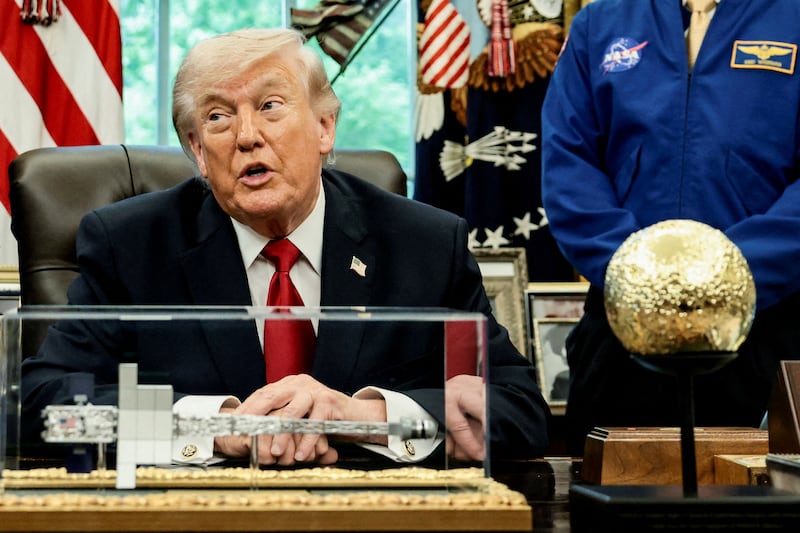 Trump at his desk with golden moon