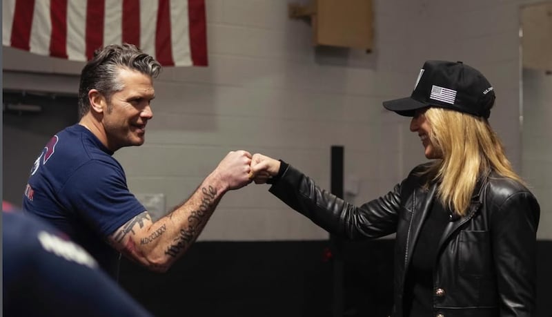 Pete Hegseth fist-bumps his wife, Jennifer.