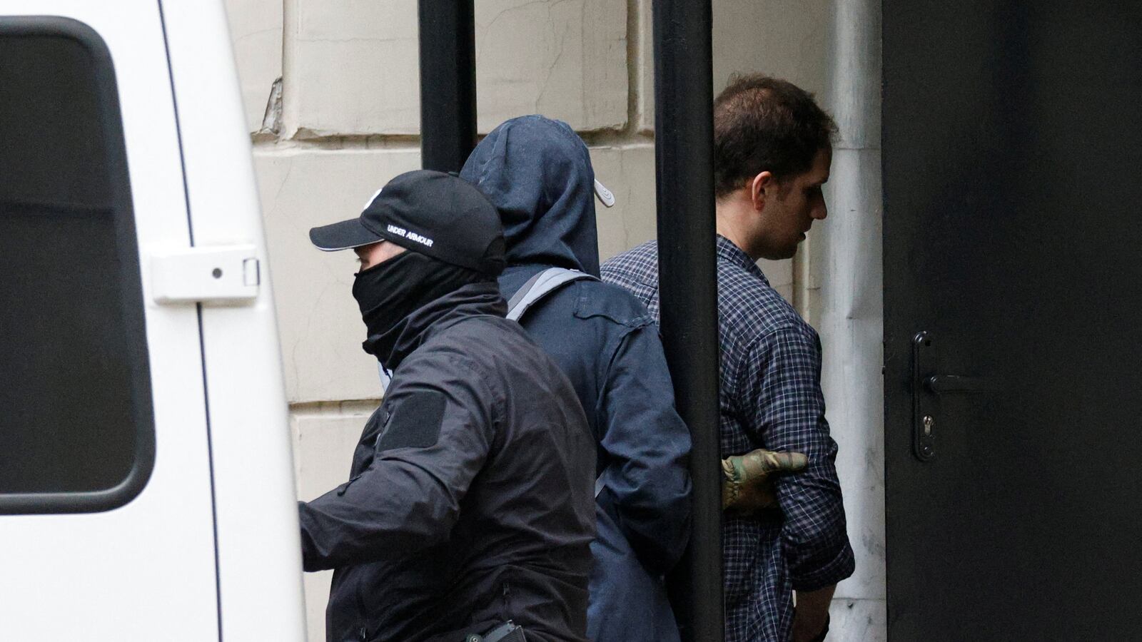 Wall Street Journal reporter Evan Gershkovich, who was arrested in March while on a reporting trip and accused of espionage, is escorted into a court building before a hearing on extending his pre-trial detention, in Moscow, Russia, Aug. 24, 2023.
