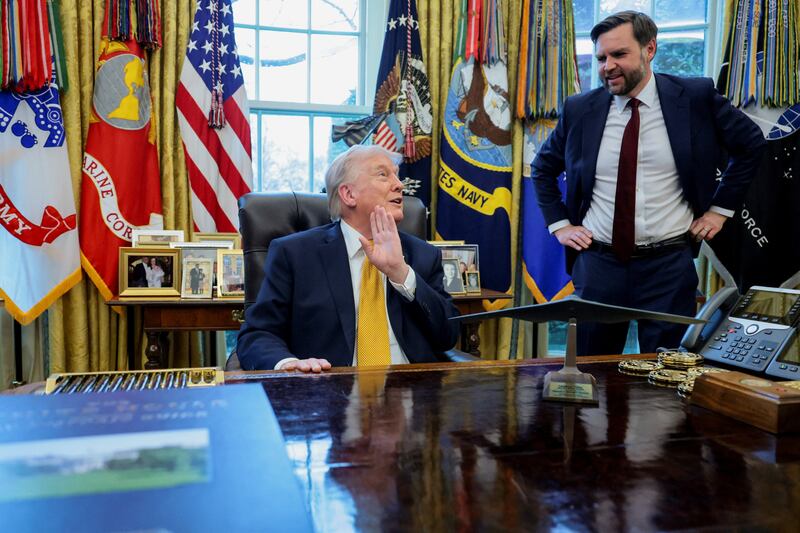 U.S. President Donald Trump and U.S. Vice President JD Vance interact during an event to sign an executive order creating an anti‑fraud task force headed by Vance, in the Oval Office at the White House in Washington, D.C., U.S., March 16, 2026. REUTERS/Jonathan Ernst