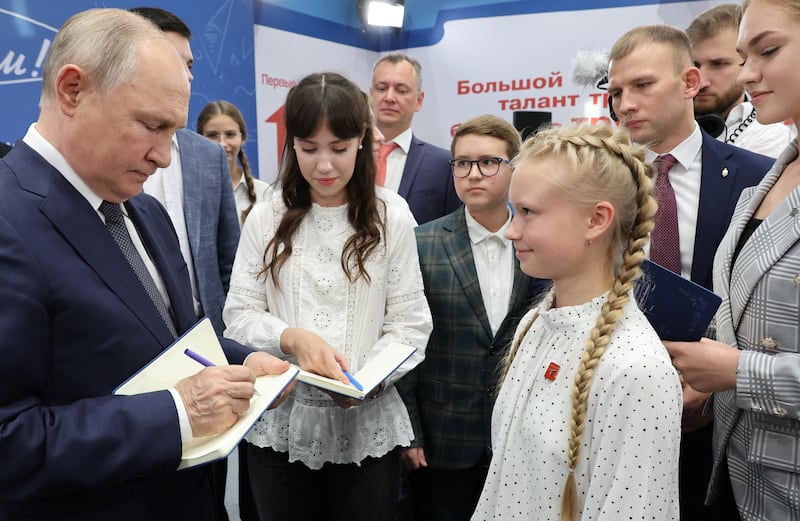 Russian President Vladimir Putin signs autographs for schoolchildren at the Senezh Management Lab in Solnechnogorsk, Moscow region, Russia September 1, 2023.