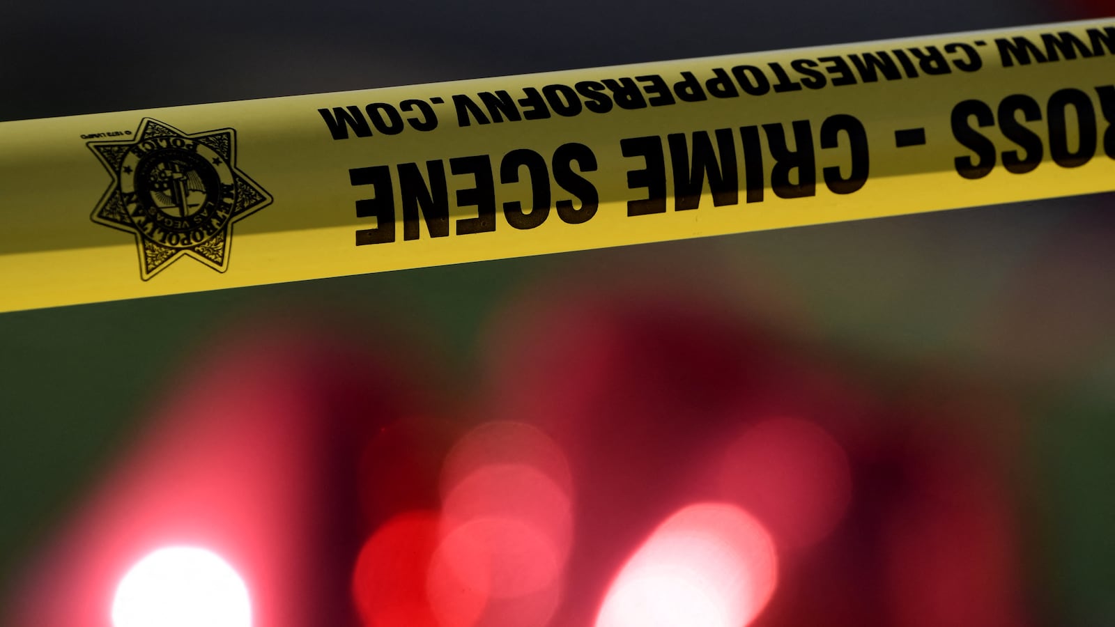 Crime scene tape and red balloons outside the Route 91 festival venue on October 3, 2017 after a gunman killed more than 59 people and wounded more than 527 others when he opened fire on a country music festival in Las Vegas, Nevada