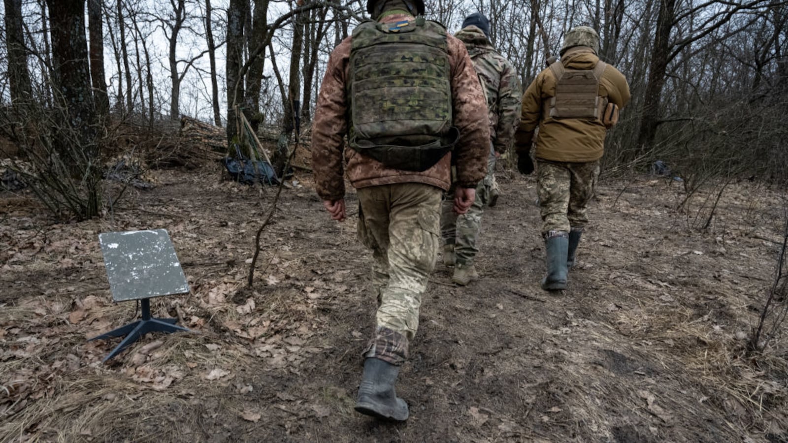 Soldiers of the Ukraine Army walk past a Starlink satellite internet receiver on February 18, 2024 in an undisclosed location, Ukraine.