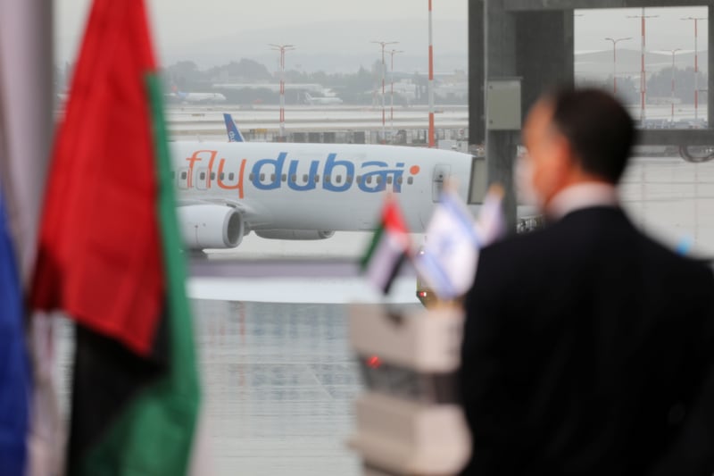 A part of a United Arab Emirates airline flydubai airliner is seen through a glass panel during a welcoming ceremony attending by Israeli Prime Minister Benjamin Netanyahu upon its landing at Ben Gurion International Airport, near Tel Aviv, Israel November 26, 2020. REUTERS/Emil Salman/Pool