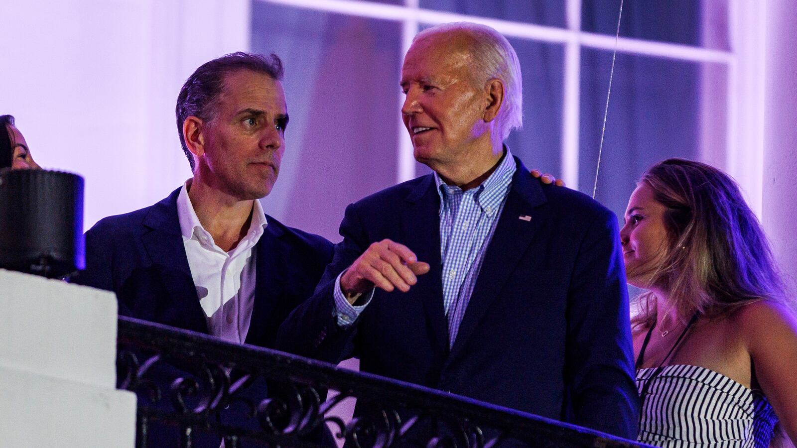 President Joe Biden talks to his son, Hunter Biden, on the White House balcony during a 4th of July event on the South Lawn of the White House on July 4, 2024 in Washington, DC.