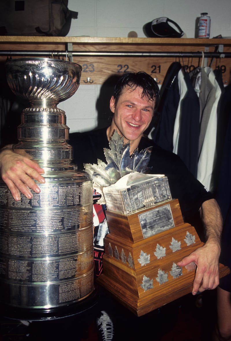 EAST RUTHERFORD, NJ - JUNE 24: Claude Lemieux #22 of the New Jersey Devils celebrates with the Stanley Cup and the Conn Smythe Trophy after winning 1995 Stanley Cup playoffs against the Detroit Red Wings at Meadowlands Sports Complex on June 24, 1995 in East Rutherford, New Jersey. (Photo by: B Bennett/Getty Images)