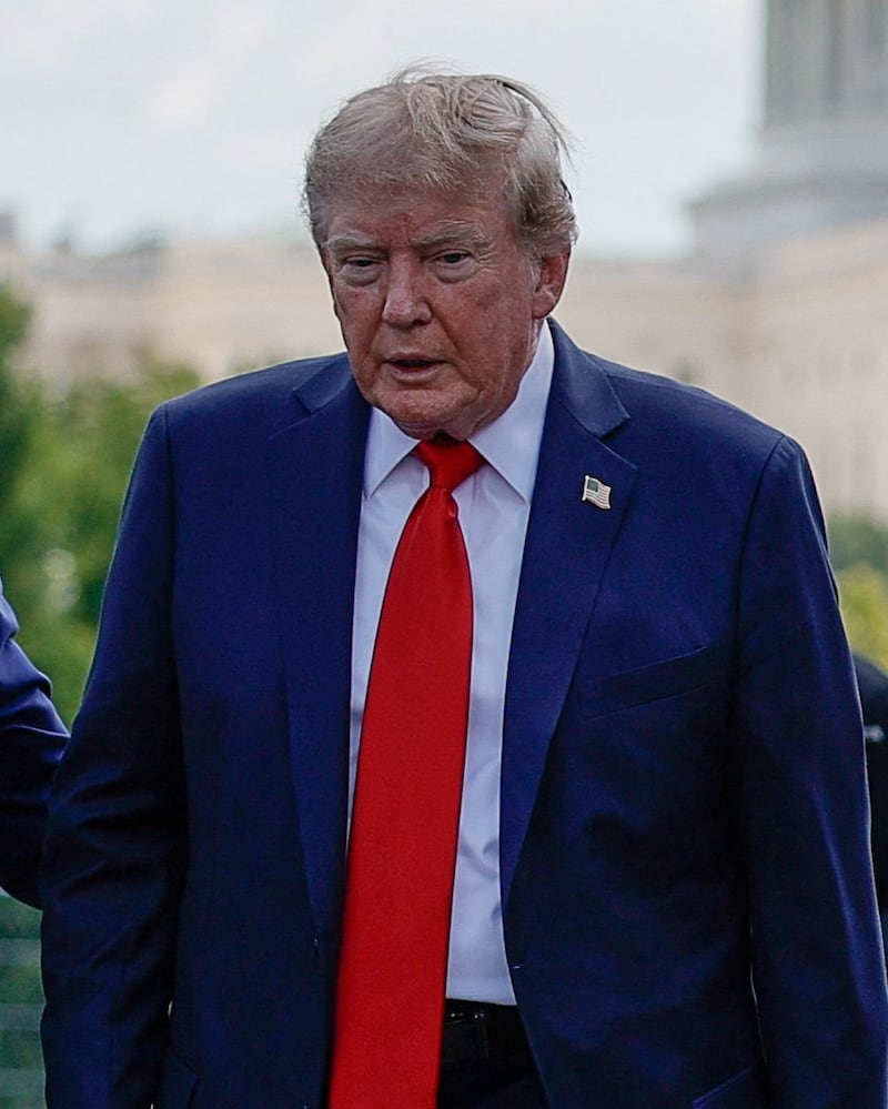 U.S. President Donald Trump stands with Bud Denker, President of the Penske Corporation and Executive Vice President of Team Penske, as he attends the Freedom 250 Grand Prix IndyCar series race in Washington, D.C., U.S., August 23, 2026. REUTERS/Evan Vucci