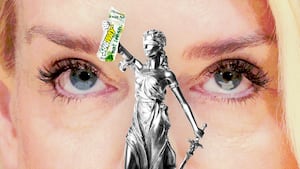 Pam Bondi looking at Lady Justice holding a Subway sandwich