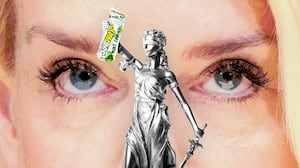 Pam Bondi looking at Lady Justice holding a Subway sandwich