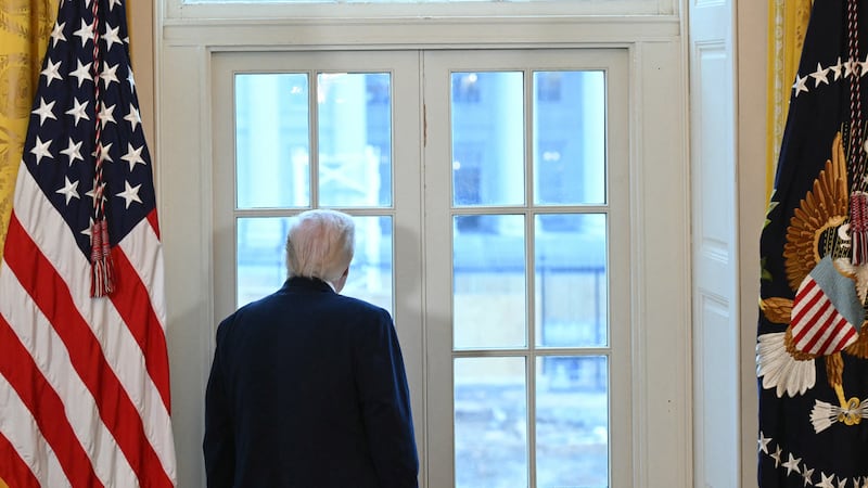 US President Donald Trump looks through a window to observe construction work on his new ballroom prior to a meeting with US oil company executives in the East Room of the White House in Washington, DC, on January 9, 2026. President Trump is aiming to convince oil executives to support his plans in Venezuela, a country whose energy resources he says he expects to control for years to come. US forces seized Venezuelan president Nicolas Maduro in a sweeping military operation on January 3, with Trump making no secret that control of Venezuela's oil was at the heart of his actions. (Photo by SAUL LOEB / AFP via Getty Images)