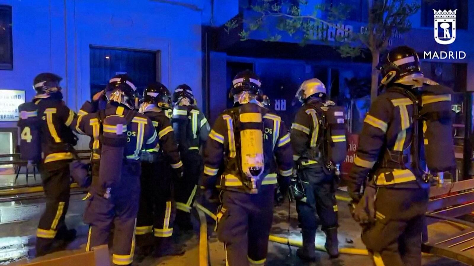 Firefighters gather outside a restaurant following a fire, in Madrid, Spain, April 21, 2023, in this screen grab taken from a handout video.