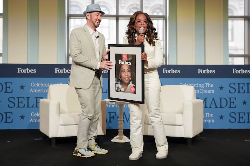 PHILADELPHIA, PENNSYLVANIA - JUNE 17: (L-R) Randall Lane presents Oprah Winfrey with an award during the Forbes Self-Made 250 Celebration at the Museum of the American Revolution on June 17, 2026 in Philadelphia, Pennsylvania. (Photo by Astrida Valigorsky/Getty Images)