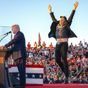 Tesla CEO Elon Musk (R) jumps on stage as he joins Donald Trump during a campaign rally at site of his first assassination attempt in Butler, Pennsylvania on October 5, 2024.