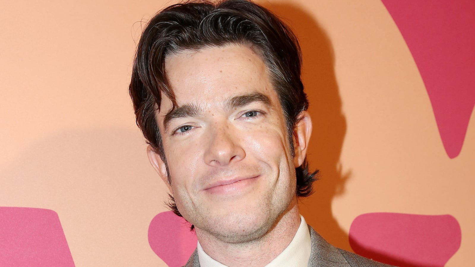 John Mulaney smiles