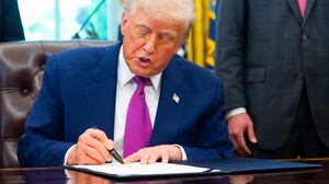 Donald Trump signs on legislation relating to household consumer energy policies, in the Oval Office of the White House in Washington, DC, on May 9, 2025.
