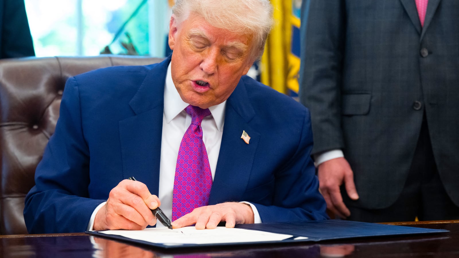 Donald Trump signs on legislation relating to household consumer energy policies, in the Oval Office of the White House in Washington, DC, on May 9, 2025.