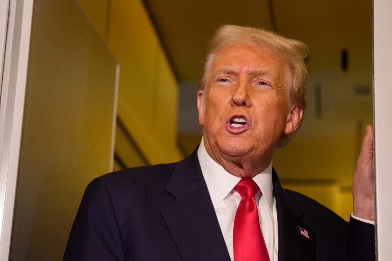 President Donald Trump speaks to members of the media aboard Air Force One on October 30, 2025.