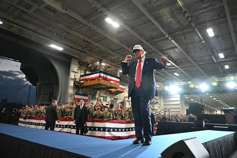 US President Donald Trump dances as he leaves after delivering a speech in front of US Navy personnel on board the US Navy's USS George Washington