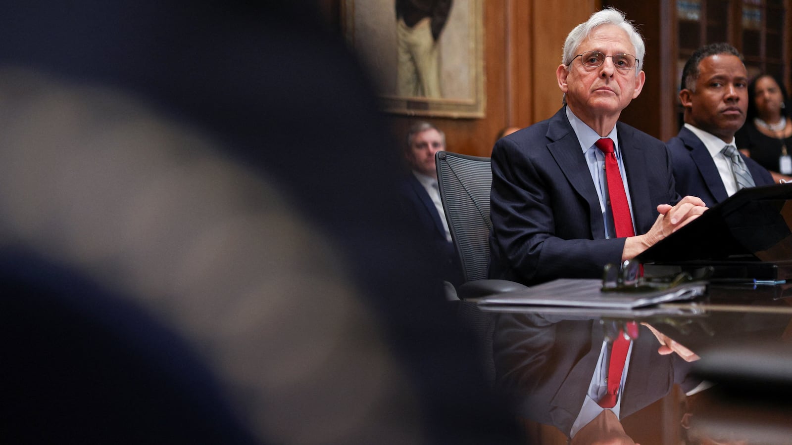 U.S. Attorney General Merrick Garland sits beside Assistant Attorney General Kenneth Polite.