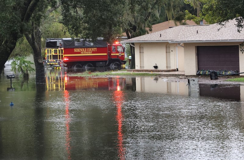 A Seminole County Fire Department rescue truck drives through the flooded Springs Oaks Boulevard in Altamonte Springs, Florida, on Oct. 10, 2024.