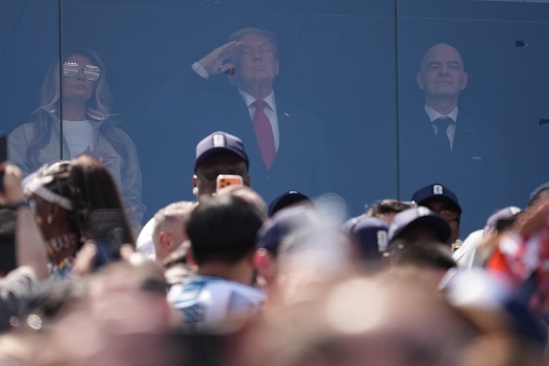 First Lady Melania Trump, United States President Donald Trump and FIFA President Gianni Infantino stand ahead of the 2026 World Cup football final between Spain and Argentina.
