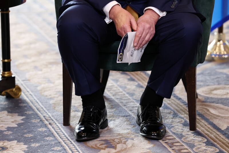 Make-up covers the back of the right hand of U.S. President Donald Trump, as he meets with European Commission President Ursula von der Leyen (not pictured), after the announcement of a trade deal between the U.S. and EU, in Turnberry, Scotland, Britain, July 27, 2025. REUTERS/Evelyn Hockstein