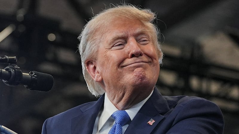 Donald Trump smiles as he delivers remarks at the David S. Mack Center for Training and Intelligence in Garden City, New York.