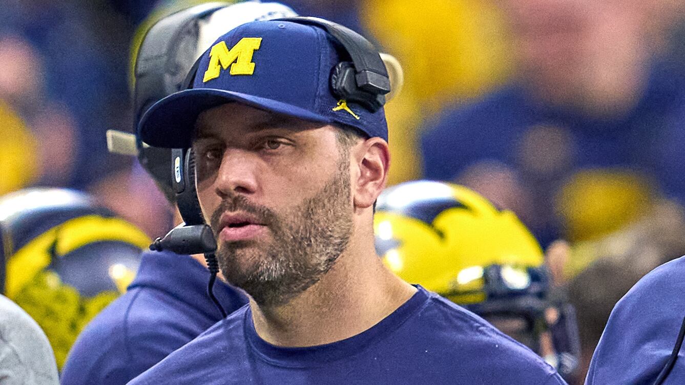 INDIANAPOLIS, IN - DECEMBER 04: Michigan Wolverines Offensive Line/Co-Offensive Coordinator Sherrone Moore and Quarterbacks Coach Matt Weiss look on during the Big Ten Championship Game between the Iowa Hawkeyes and the Michigan Wolverines on December 04, 2021, at Lucas Oil Stadium, in Indianapolis, IL.