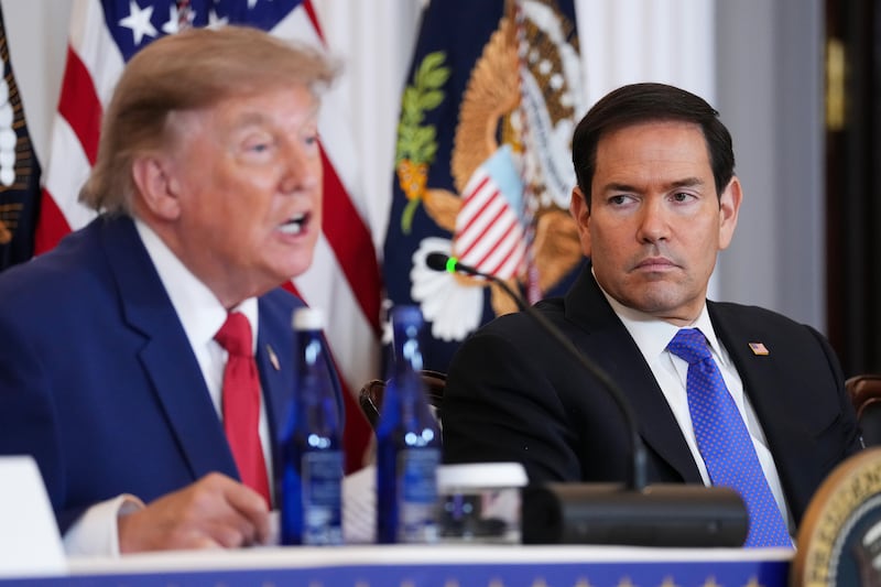 Secretary of State Marco Rubio listens as President Donald Trump speaks during a roundtable on the American mining industry at the U.S. Department of State on August 07, 2026 in Washington, DC.
