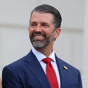 Donald Trump Jr. talks with his partner Bettina Anderson