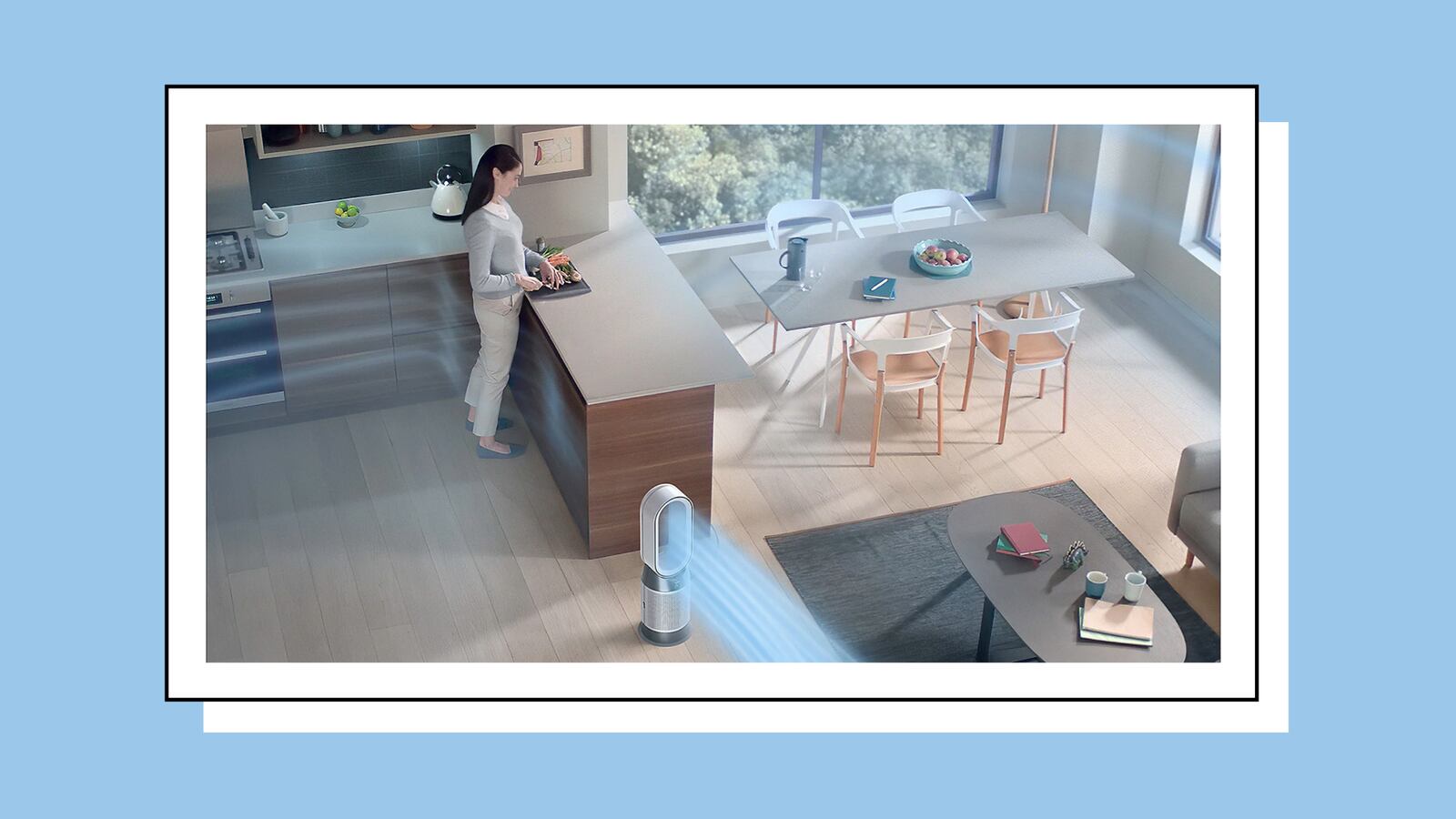 A modern open kitchen and dining area with a woman preparing food at a counter. A bladeless air purifier stands on the floor, releasing a visible stream of clean air across the room toward the dining table and living space.