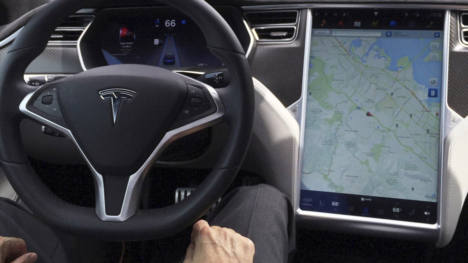 The interior of a Tesla Model S is shown in autopilot mode in San Francisco