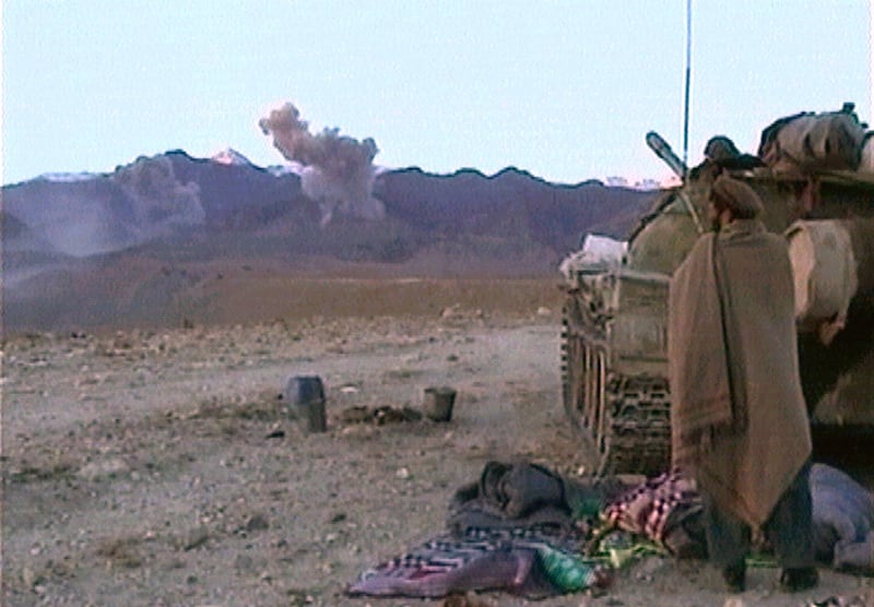 An Afghan warrior watches a U.S. bombing raid on Tora Bora in eastern Afghanistan December 10, 2001.