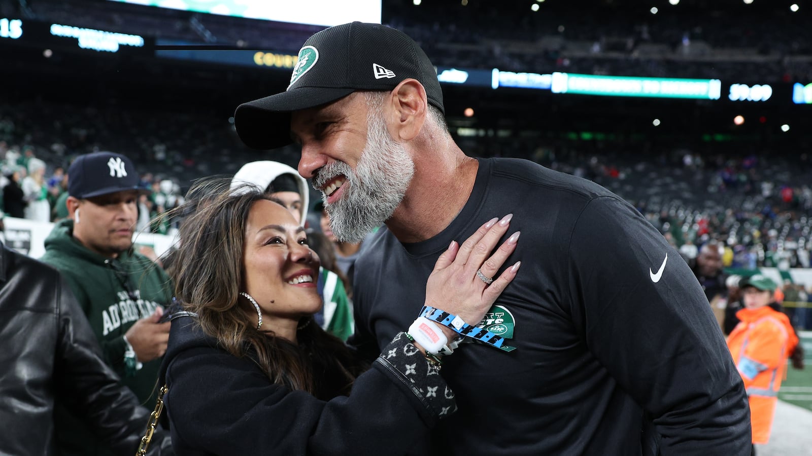 EAST RUTHERFORD, NEW JERSEY - OCTOBER 14: Interim head coach Jeff Ulbrich of the New York Jets and his wife, Cristina Ulbrich, embrace prior to the game against the Buffalo Bills at MetLife Stadium on October 14, 2024 in East Rutherford, New Jersey. (Photo by Elsa/Getty Images)