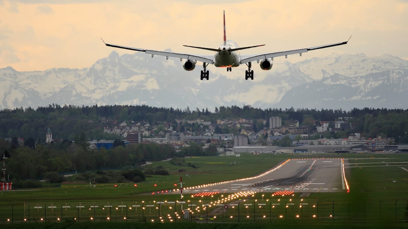 Flight landing on runway with mountains in the background