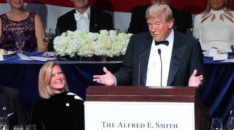 Mary Erdoes, laughs during Donald Trump's speech at the Al Smith Charity Dinner roast in New York City.