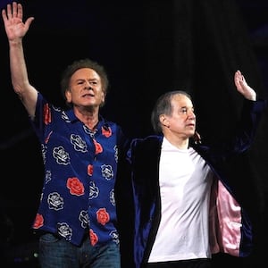 Paul Simon (R) waves with Art Garfunkel after their performance during one of two 25th Anniversary Rock & Roll Hall of Fame concerts in New York October 29, 2009.  REUTERS/Lucas Jackson (UNITED STATES ENTERTAINMENT)